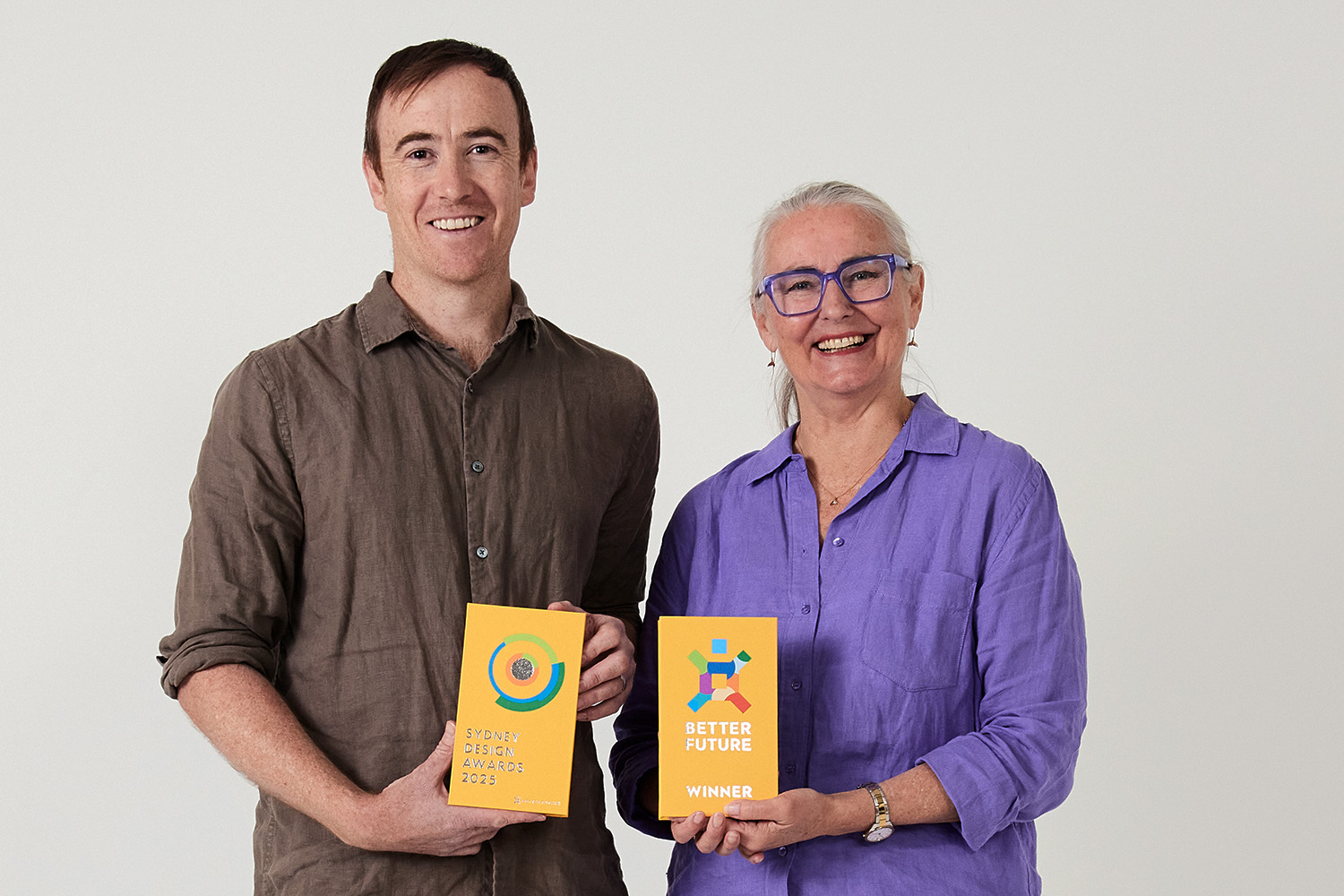 Award winning architects Archisoul Director Jo Gillies and Senior Associate Russell Rice pose with their Better Future Sydney Design Awards trophies.